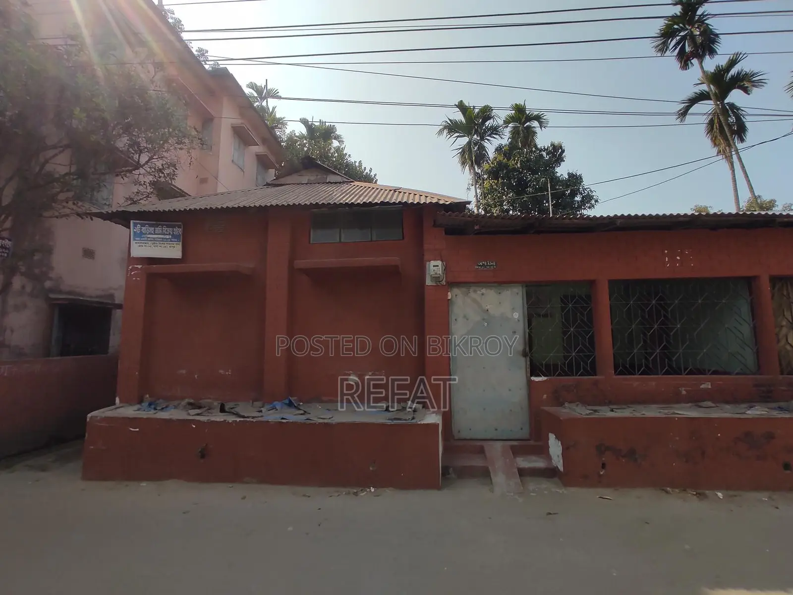 Three decimals of land with a house for sale by the roadside