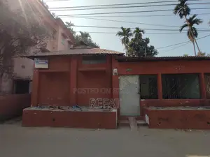 Three decimals of land with a house for sale by the roadside