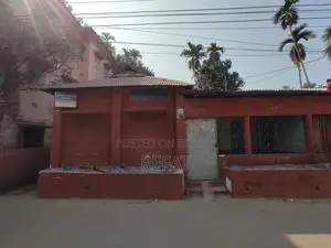 Three decimals of land with a house for sale by the roadside