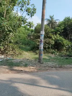 Land 2 plots away from the main road, with a 10-foot road in front