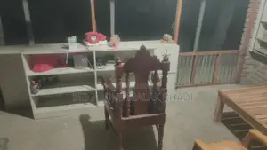 Shop front cash table, three racks, and a large wooden chair