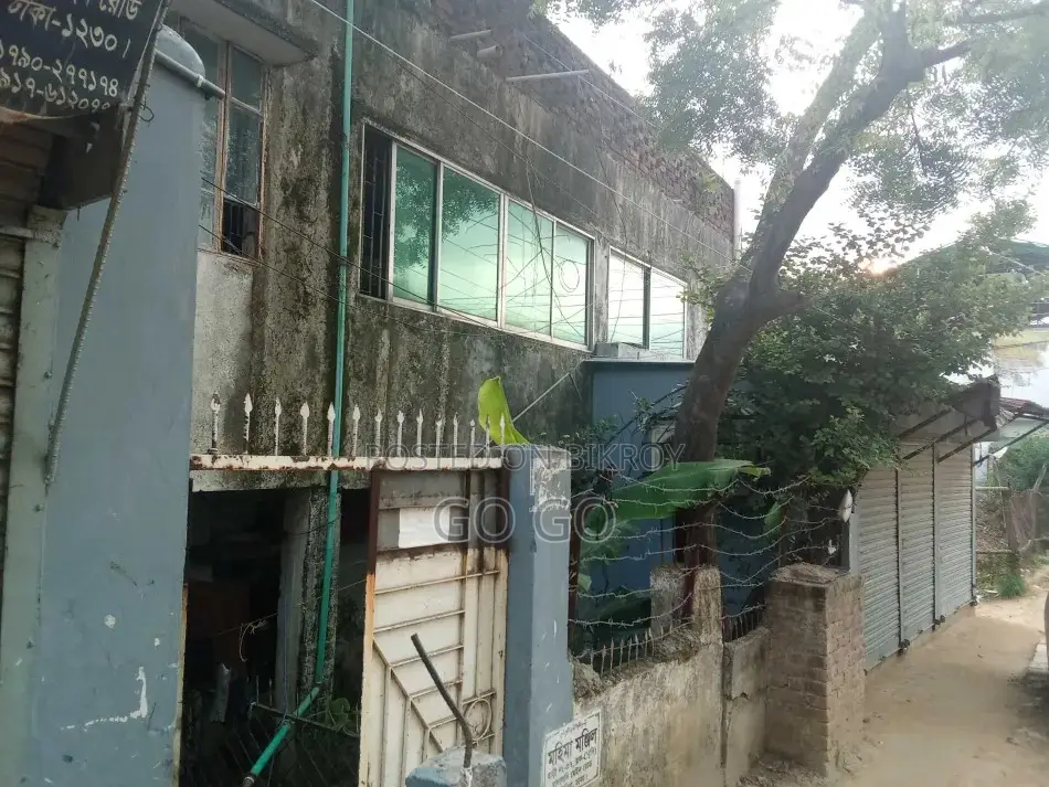 A 2-story building with 4 shops and vacant land beside it, total 4.32 Katha.