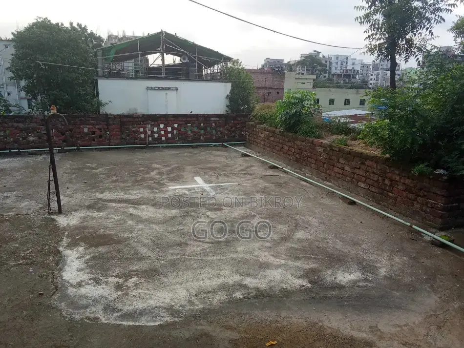 A 2-story building with 4 shops and vacant land beside it, total 4.32 Katha.