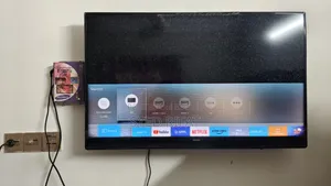 This Is A Samsung Smart Tv Featuring A Black Bezel Wall-mounted Setup