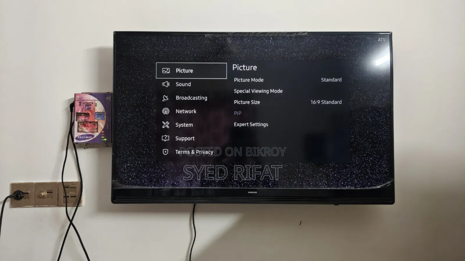This Is A Samsung Smart Tv Featuring A Black Bezel Wall-mounted Setup