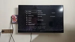 This Is A Samsung Smart Tv Featuring A Black Bezel Wall-mounted Setup