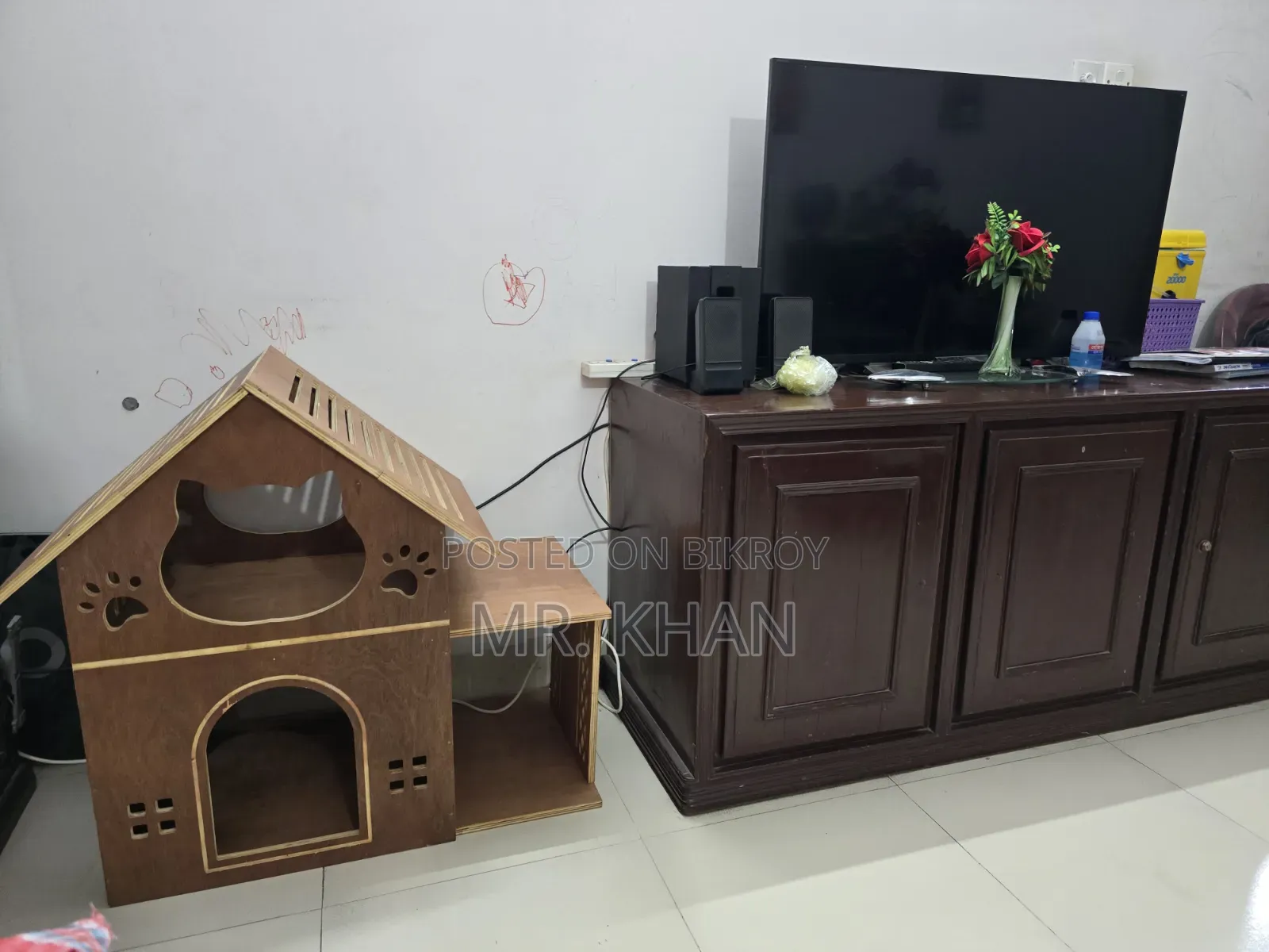 A wooden cat house for sale.