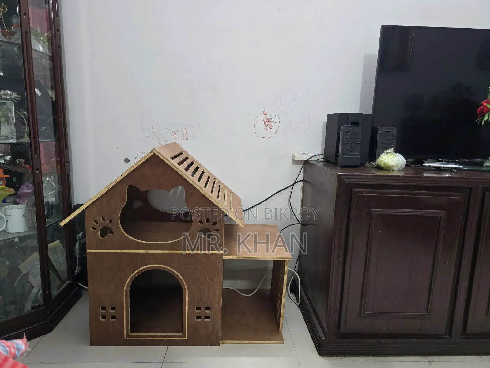 A wooden cat house for sale.