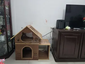 A wooden cat house for sale.